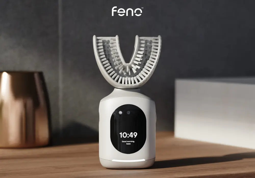 Toothbrush for gum health with U-shaped design and digital screen, placed on a wooden bathroom surface.