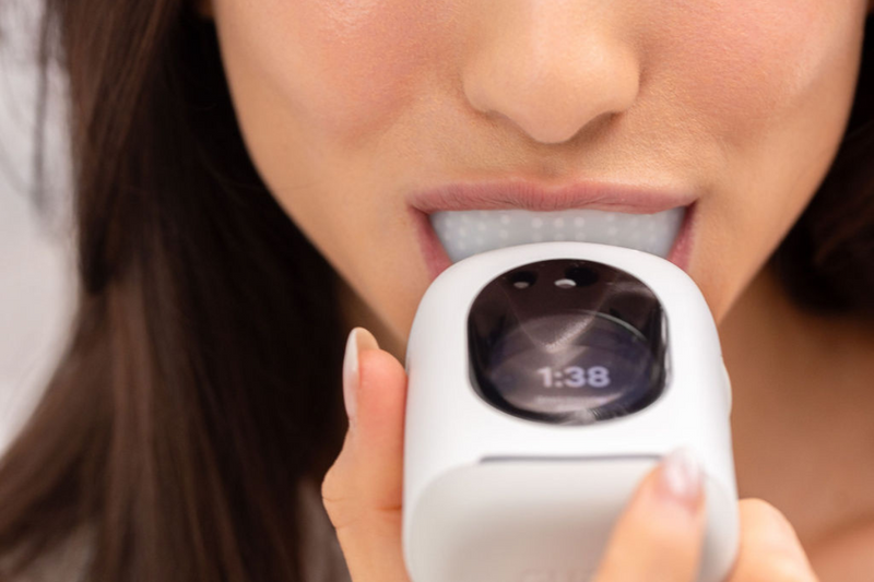 Smartbrush for oral health being used, featuring a U-shaped design & digital timer for efficient teeth cleaning