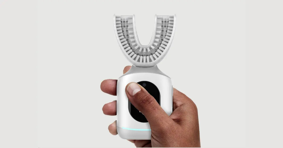 U-shaped toothbrush held in a hand, highlighting its ergonomic and user-friendly design