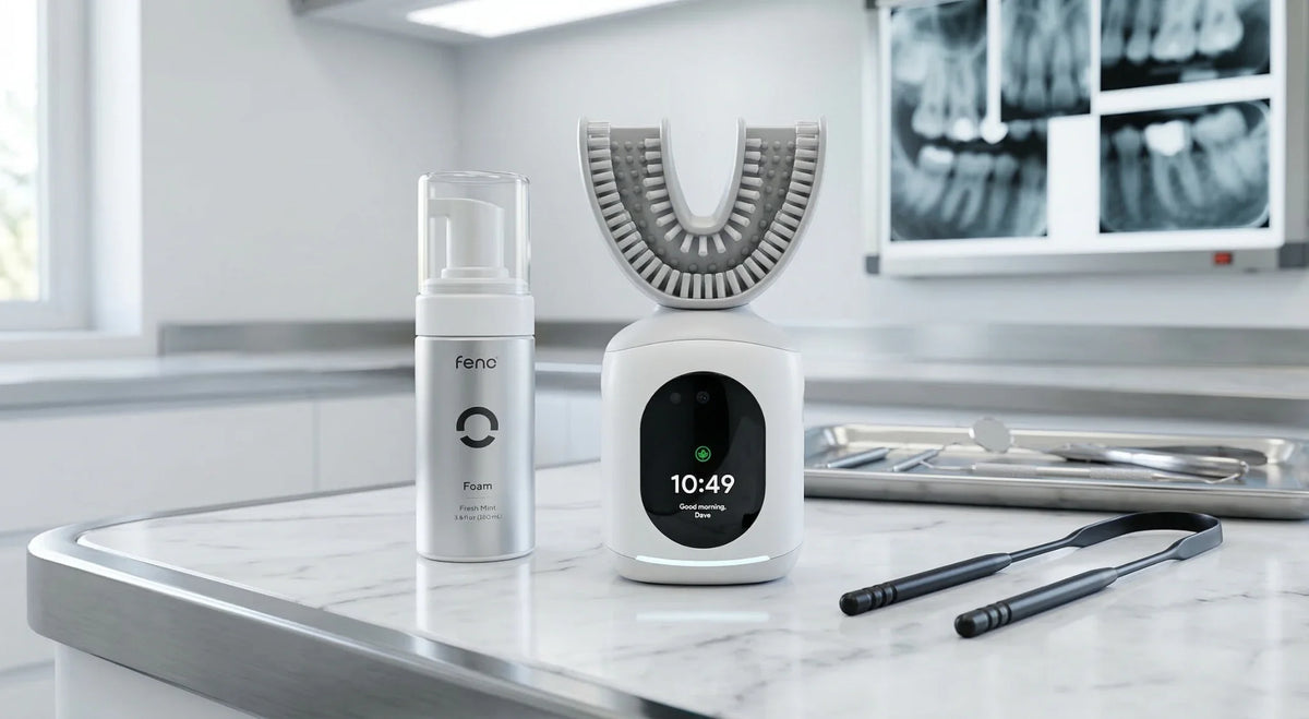 Feno U-shaped smart toothbrush with mint foam and tongue scraper on a dental counter.