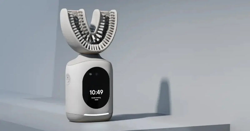U shaped toothbrush standing upright on a minimal shelf with a digital screen display.