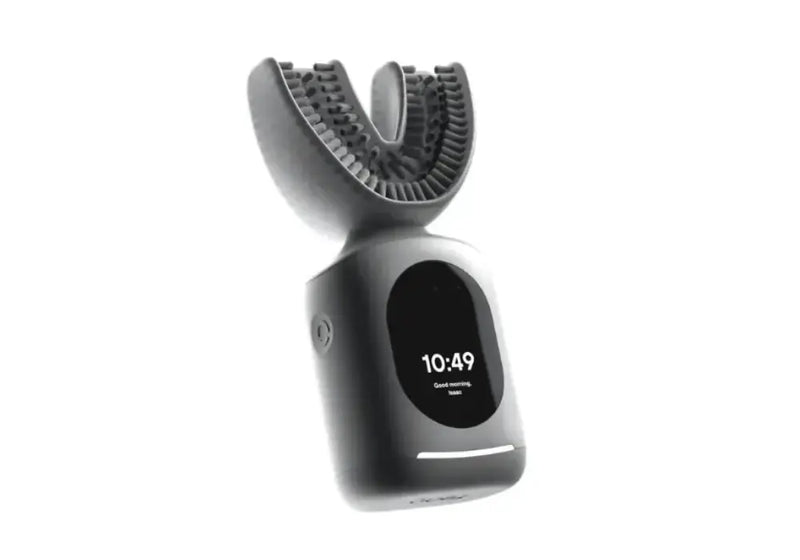 Electric toothbrush with U-shaped mouthpiece and digital clock interface floating against a white background