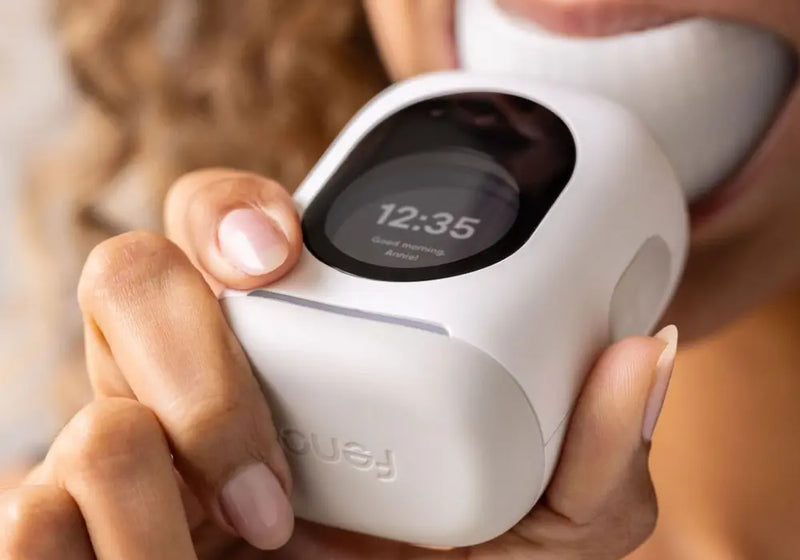 Long-term dental care device being used for automated oral hygiene with personalized settings displayed on a digital screen