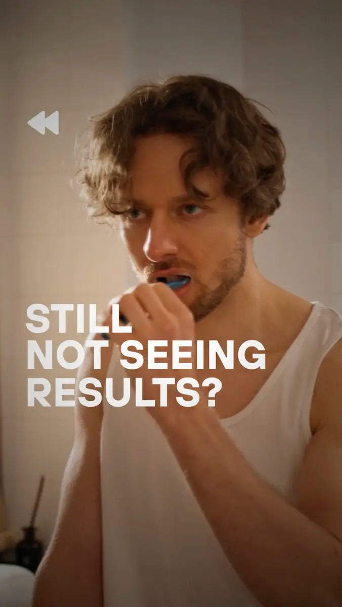 Person brushing with a manual toothbrush in bathroom, text overlay reads Still Not Seeing Results.
