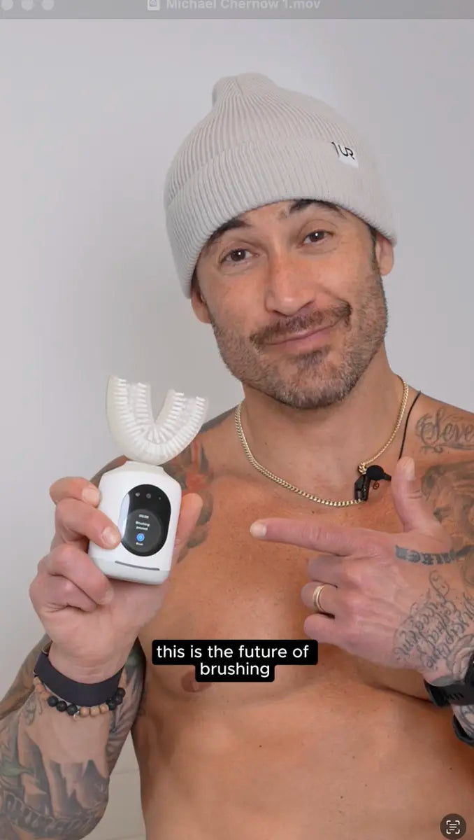 Person in beanie points at a U-shaped smart toothbrush with digital display, captioned future of brushing.