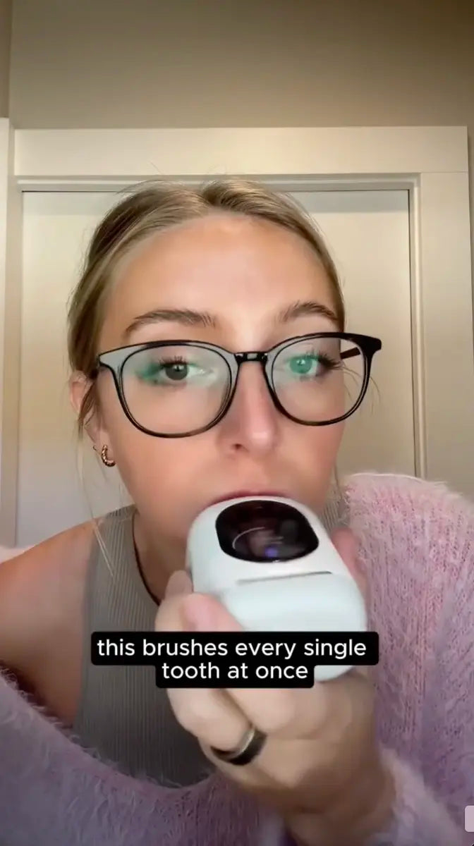 Person using a white U-shaped toothbrush that brushes every single tooth at once.