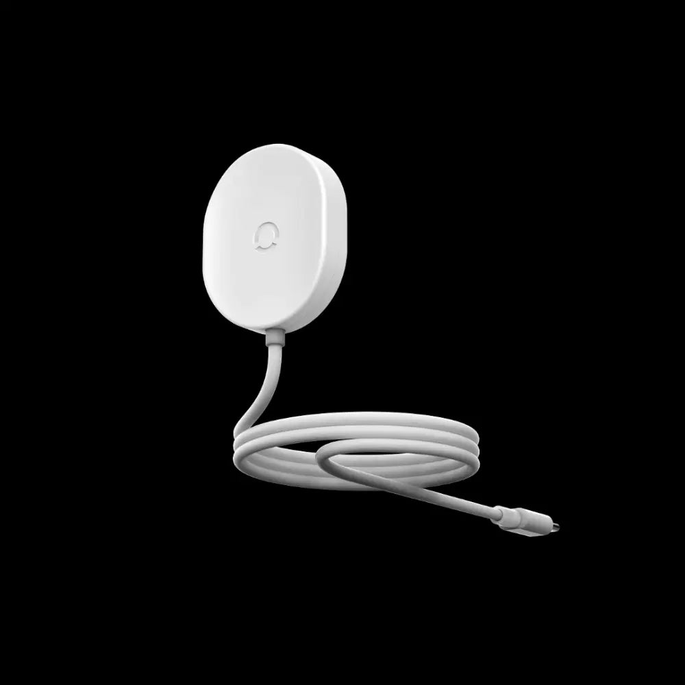 Electric toothbrush charger with a long white cable and compact charging base against a black background.